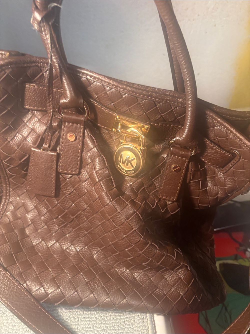 Michael Kors brown leather woven purse with lock and key